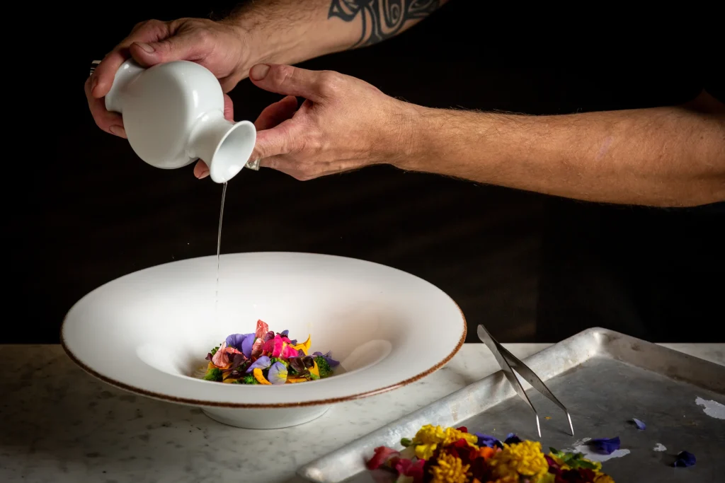 Adding a sauce while plating at Cuculia