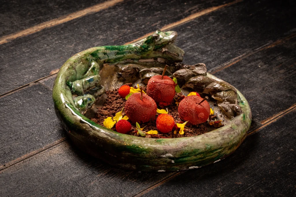 A Cuculia creation with herbs and flowers on green ceramic